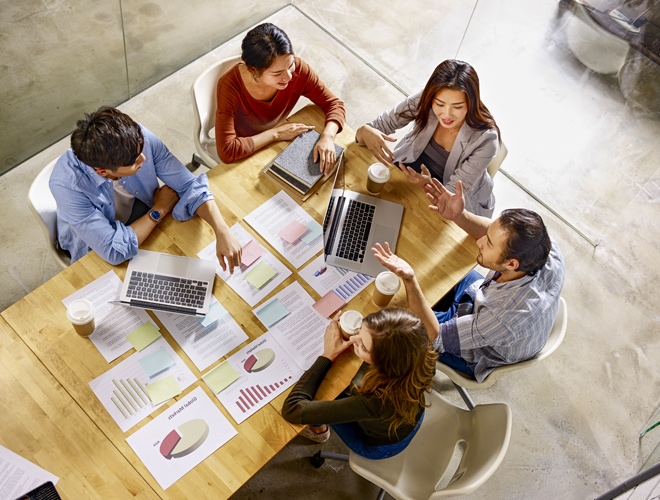 People meeting with graphics and computers